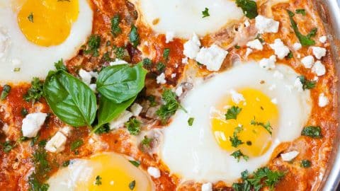 Shakshuka in a skillet, topped with 4 eggs.