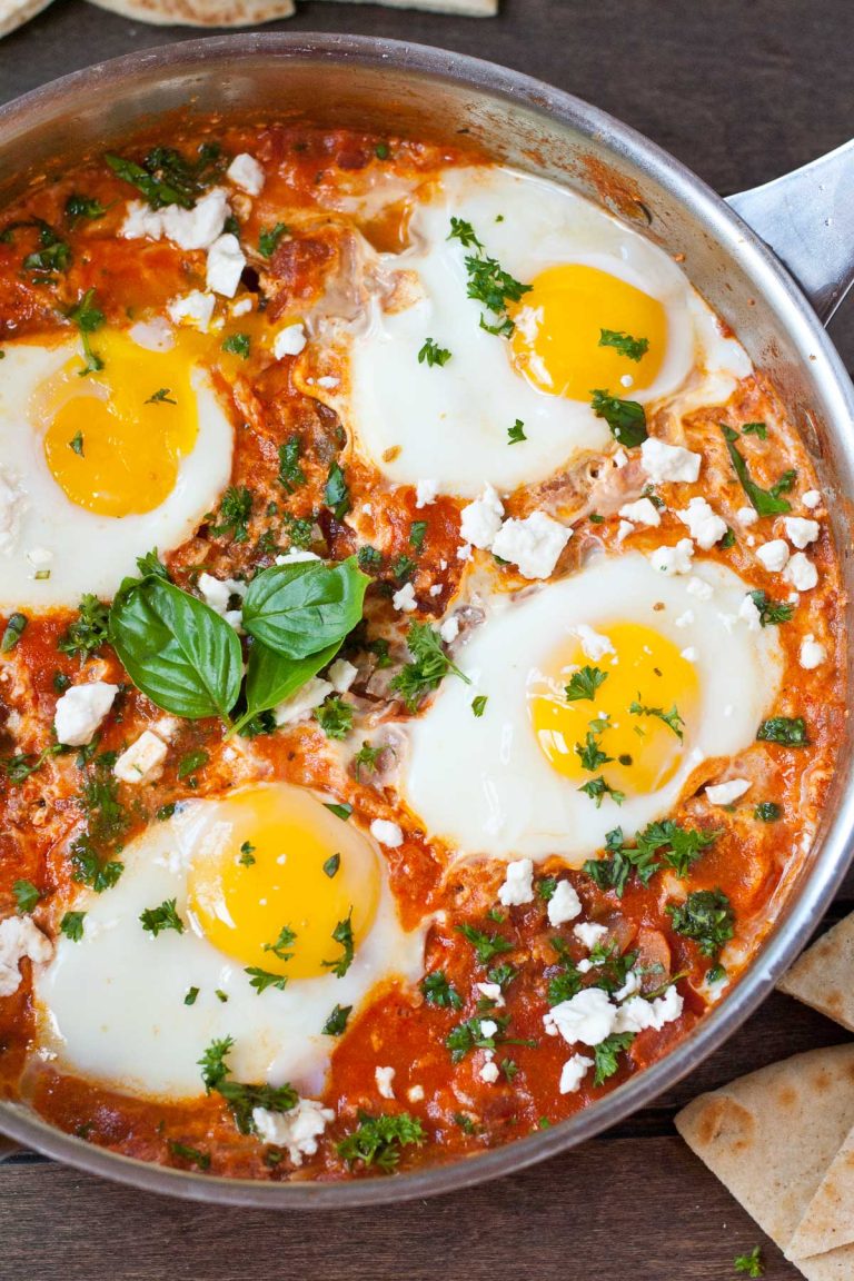 Shakshuka in a skillet, topped with 4 eggs.