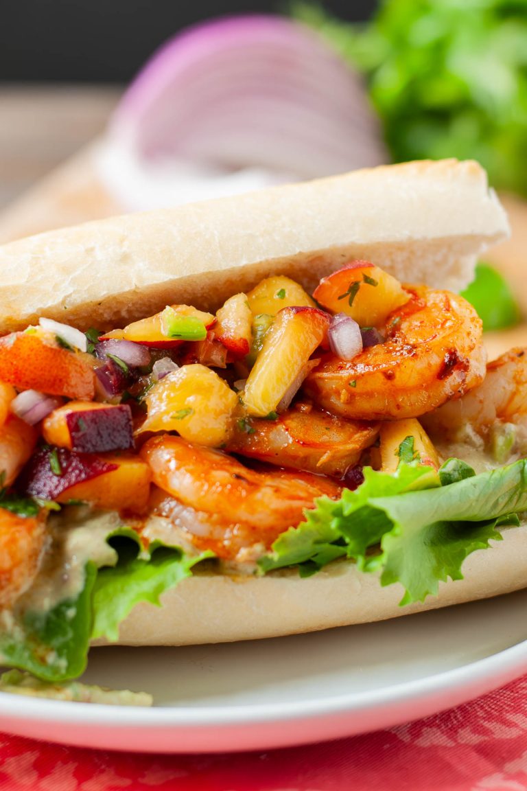 Shrimp sandwiches topped with jalapeno peach salsa.