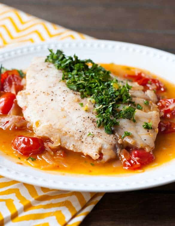 Light and fresh this Tilapia in burst tomato wine sauce is the perfect summer meal.