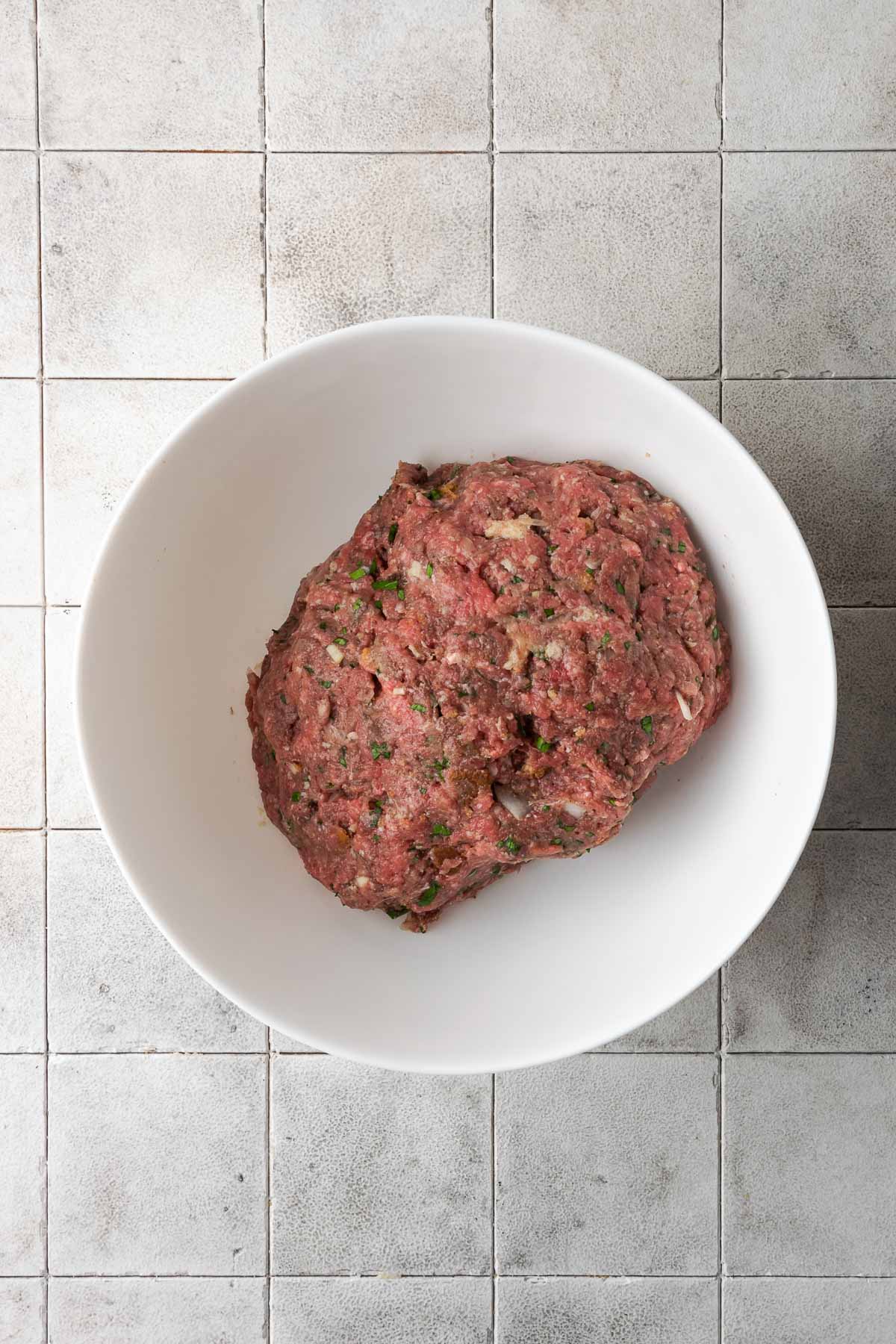Ground beef kafta meat in a bowl, before being cooked.
