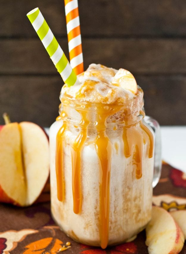 Glass mug with ice cream, apple cider, ginger ale, and caramel sauce drizzled on the outside.