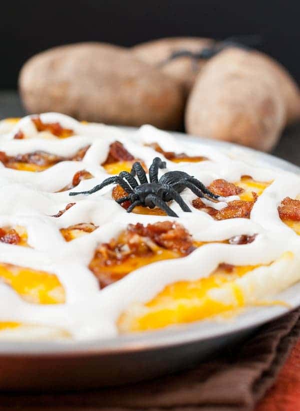 Mashed potatoes get creepy in this casserole loaded with cheese, bacon, and a sour cream spider web!