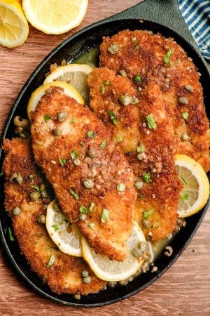 Panko crusted chicken piccata on a cast iron serving dish.