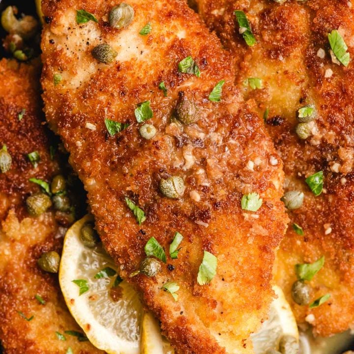 Panko chicken piccata topped with lemon butter sauce, capers, and parsley.