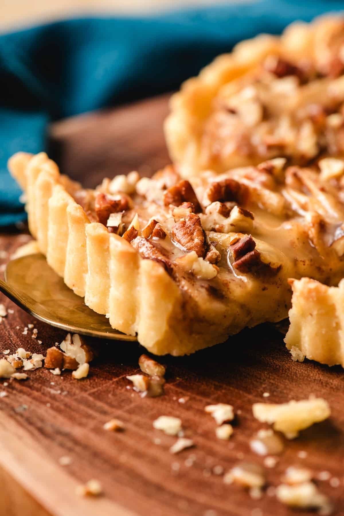 Slice of apple tart with pecans.