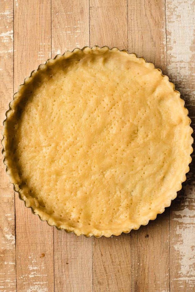Buttery French tart dough pressed into a tart pan.