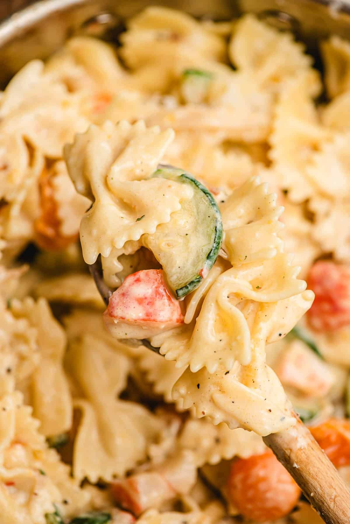 Spoonful of pantry pasta with creamy parmesan sauce.