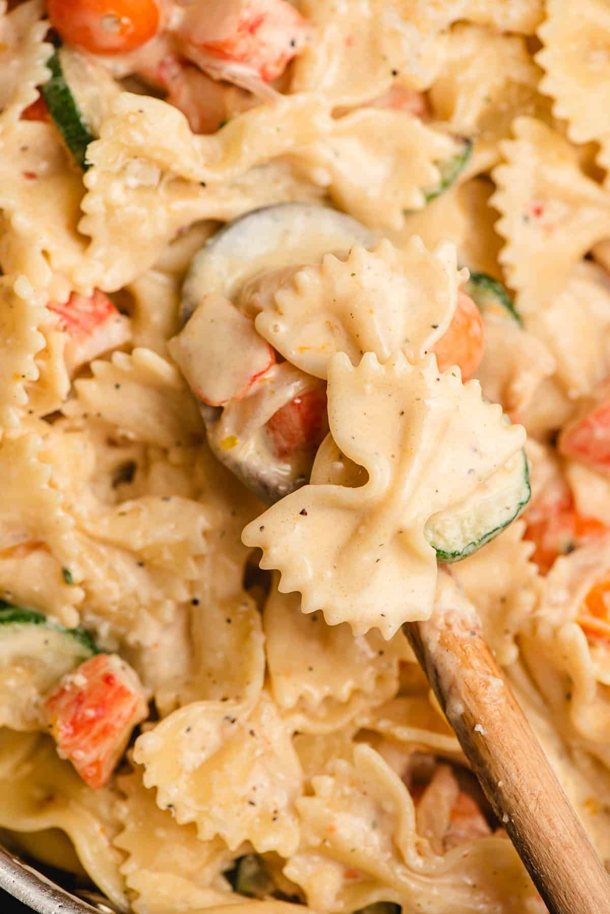 Creamy bowtie pasta with zucchini, crab, and cherry tomatoes.