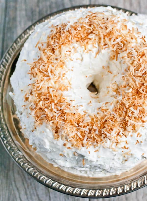 Rich, dark chocoalte bundt cake covered in a fluffy coconut sour cream frosting!