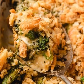 A scoop of Broccoli Ritz Casserole being lifted from the dish.