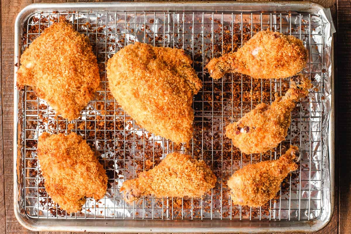 Sheet pan of baked chicken with panko breadcrumbs.
