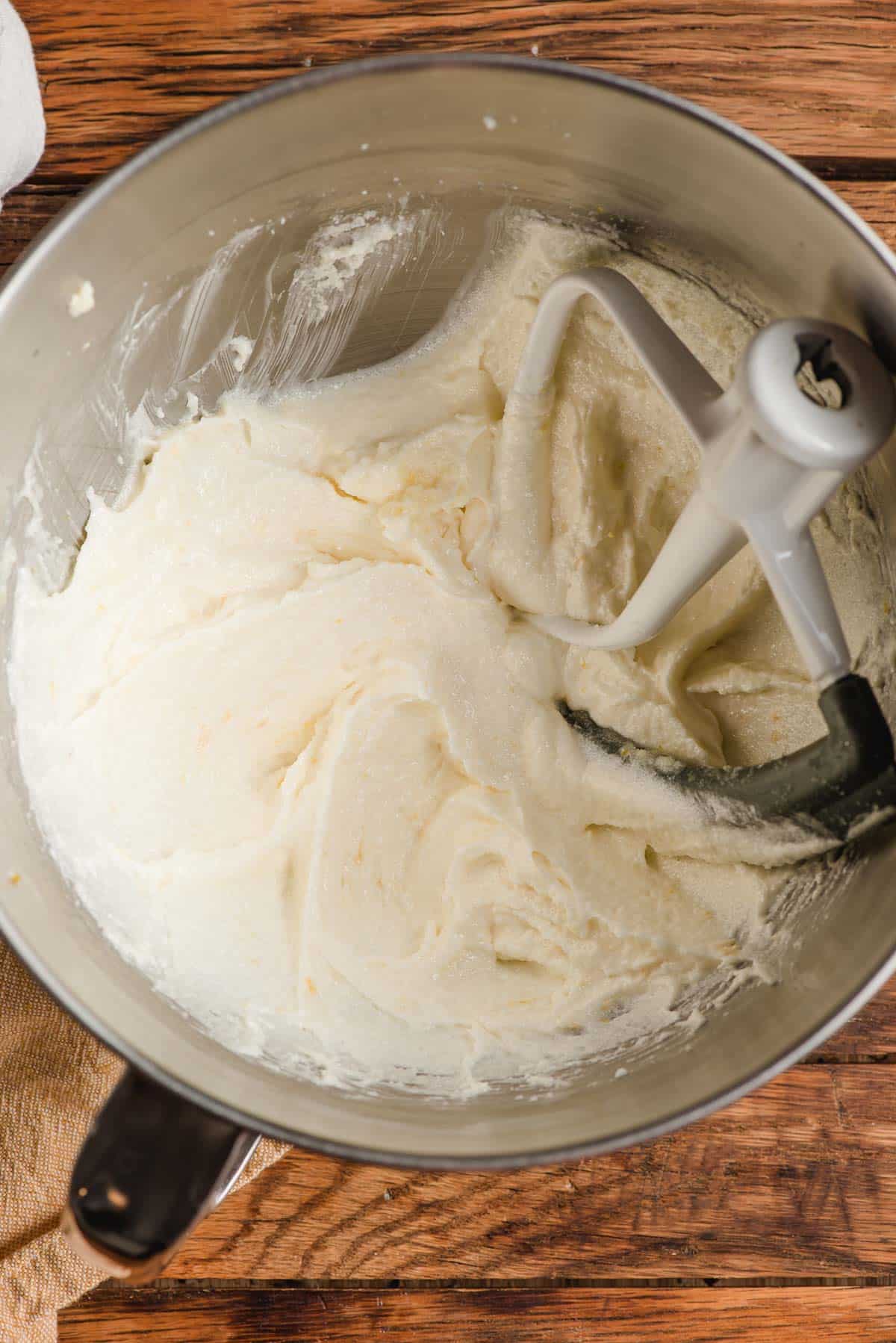 Beaten butter and sugar in a mixing bowl with a beater.