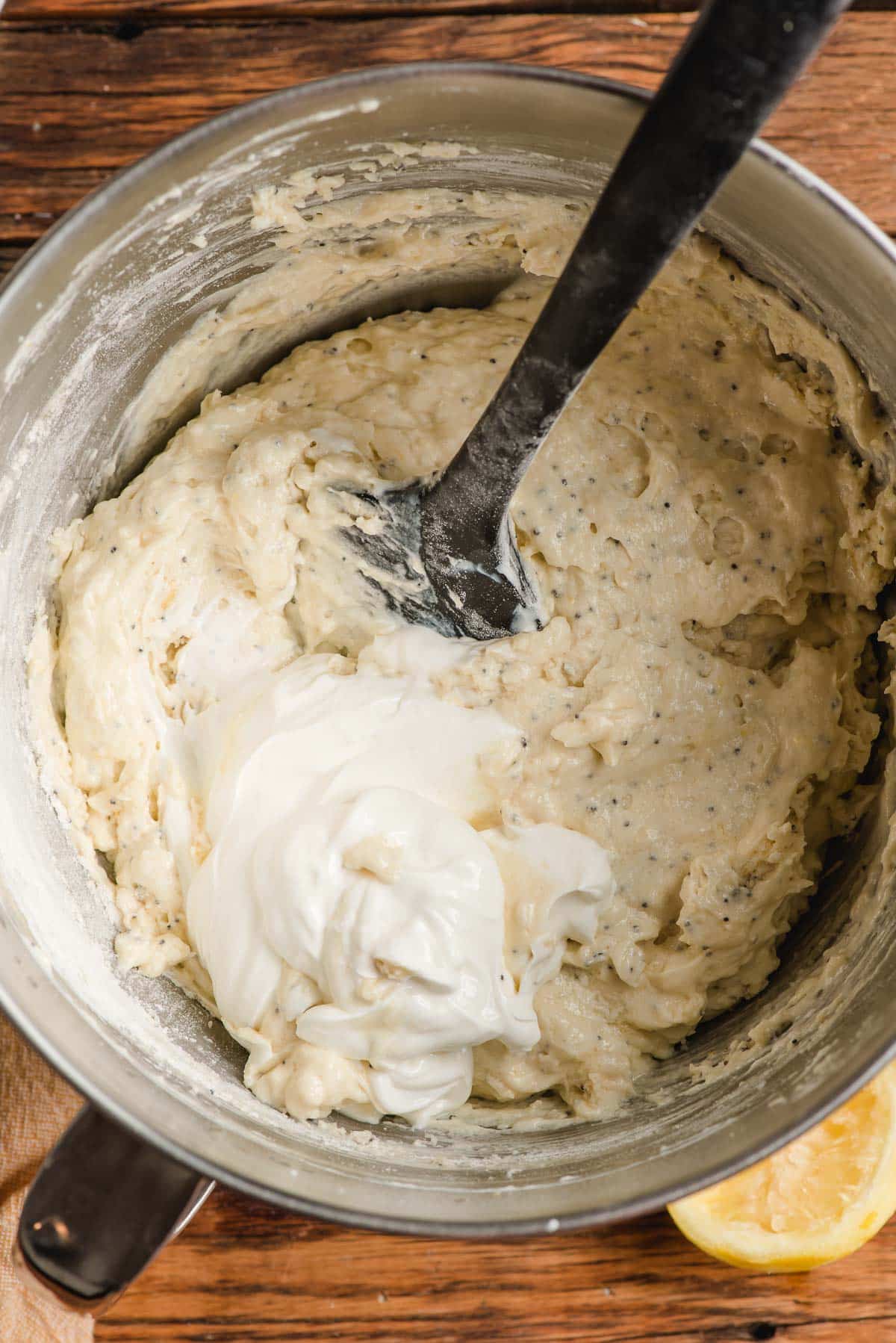 Sour cream being stirred into muffin batter.