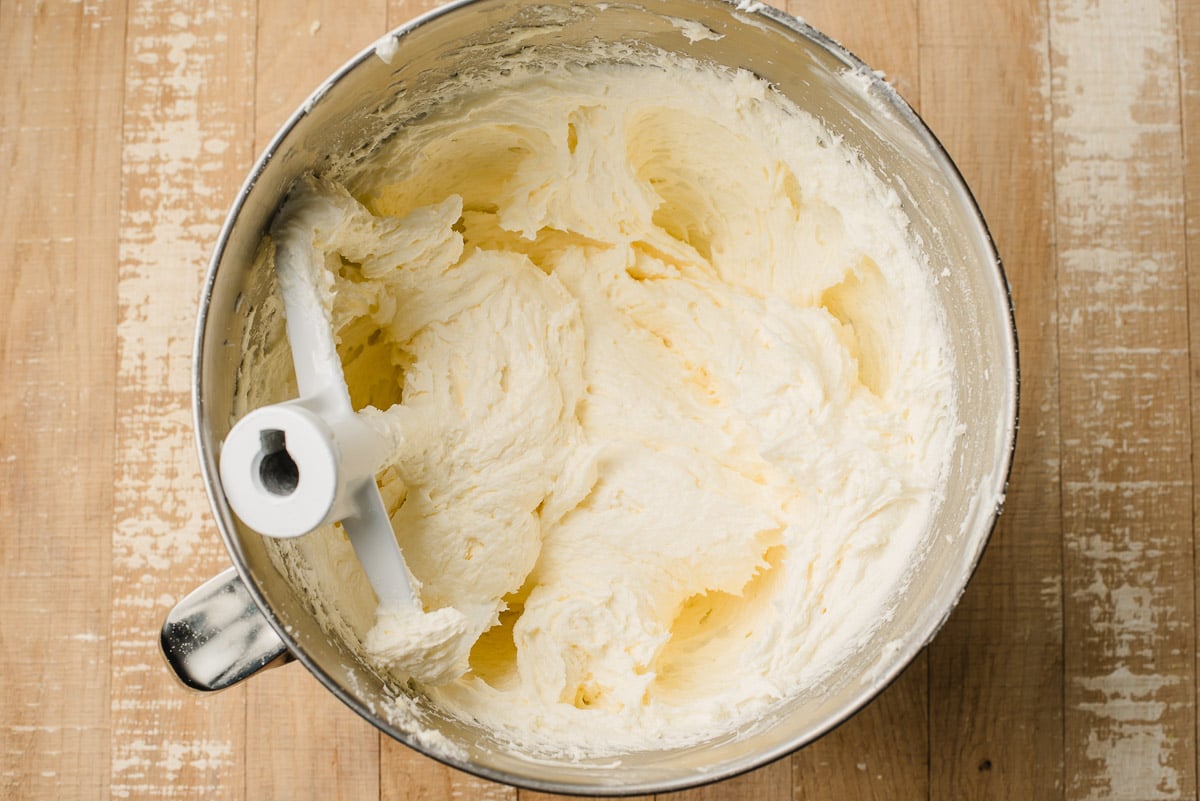 Butter creamed with sugar in a mixing bowl.