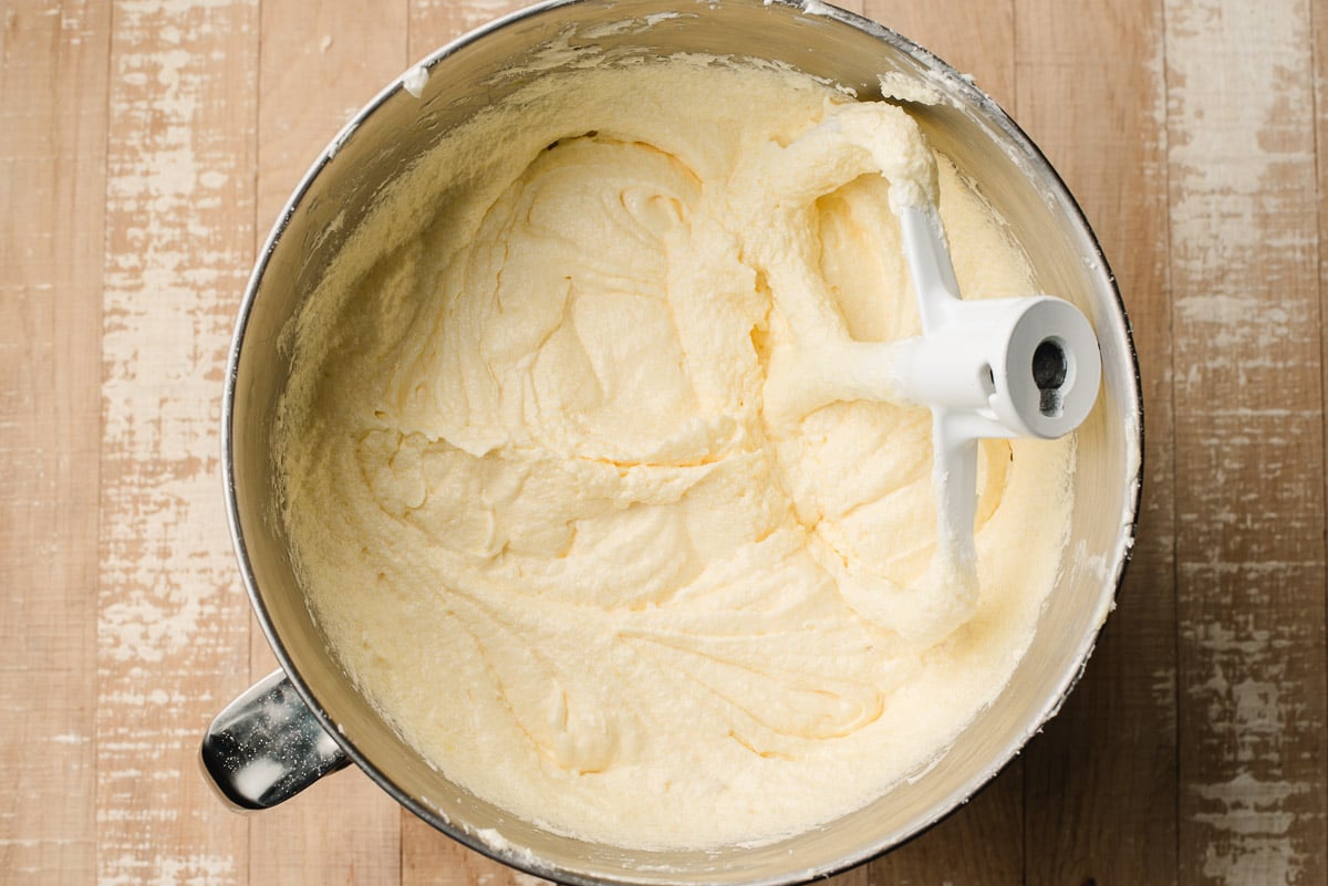 Butter creamed with sugar in a mixing bowl.