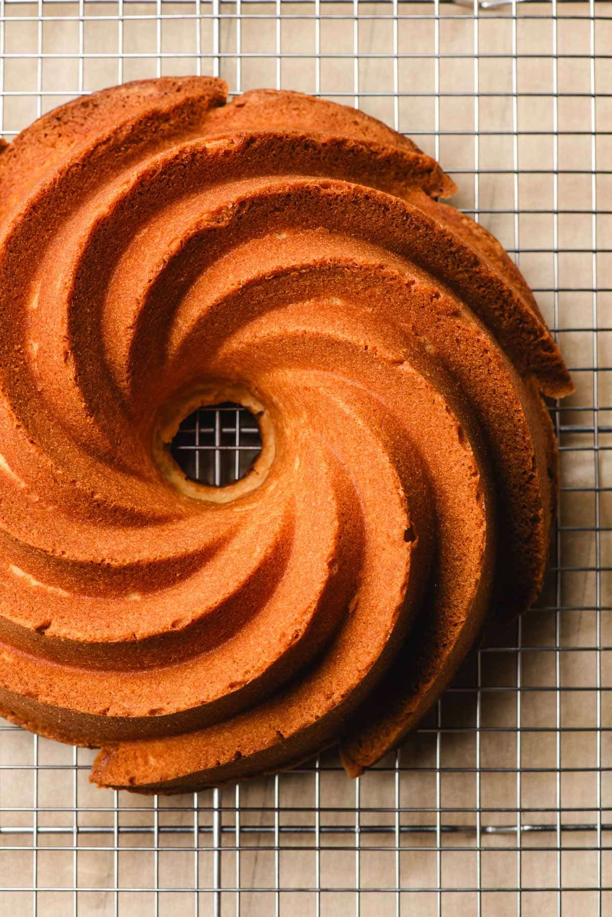 Freshly baked pound bundt cake on a wire cooling rack.