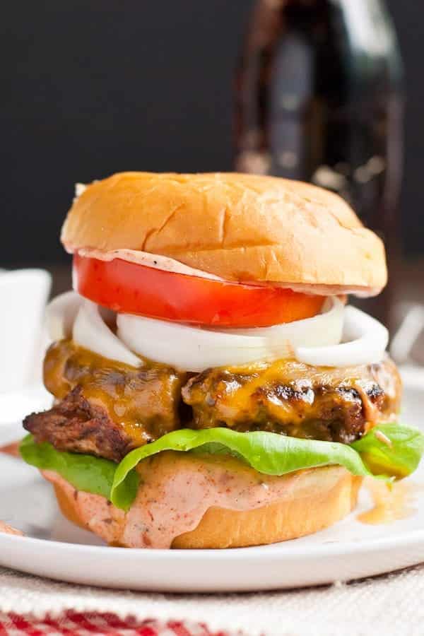 Smoky Cajun Burgers are slathered in a killer sweet and spicy Cajun sauce.