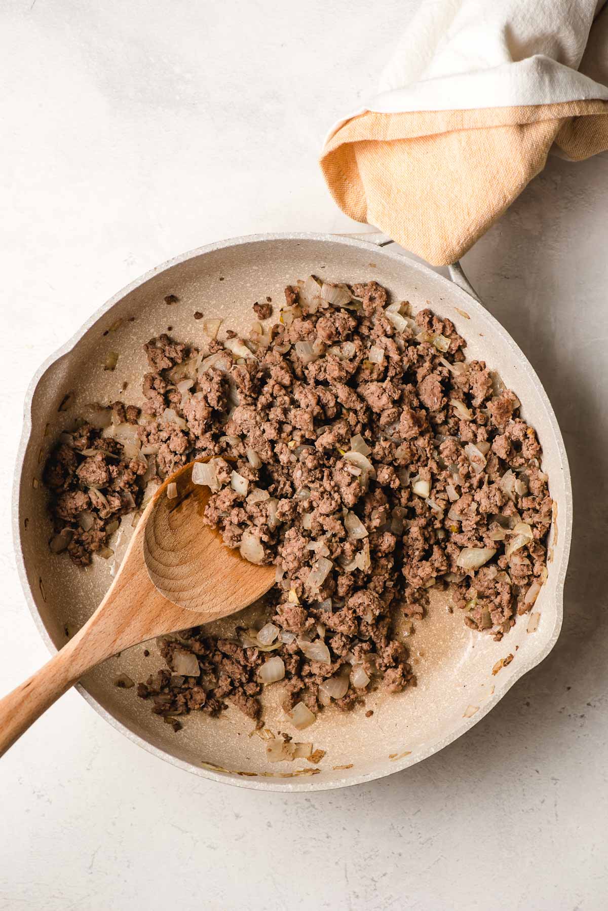 Skillet with sauteed ground beef and onions.
