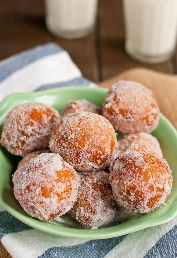 a bowl of Chinese donuts sprinkled with sugar