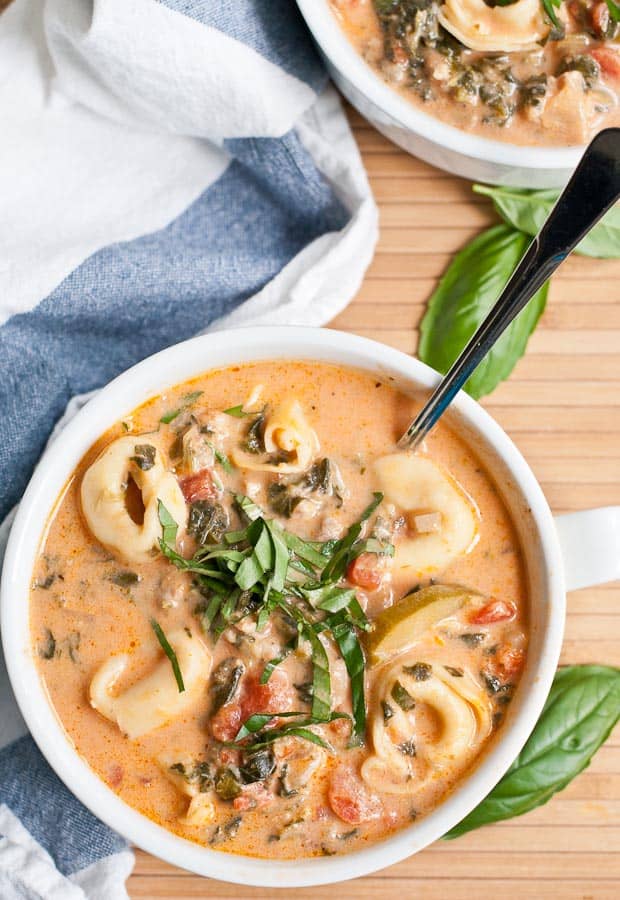 This Creamy Tortellini Soup recipe is loaded with zucchini, spinach, tomatoes, and chicken sausage!