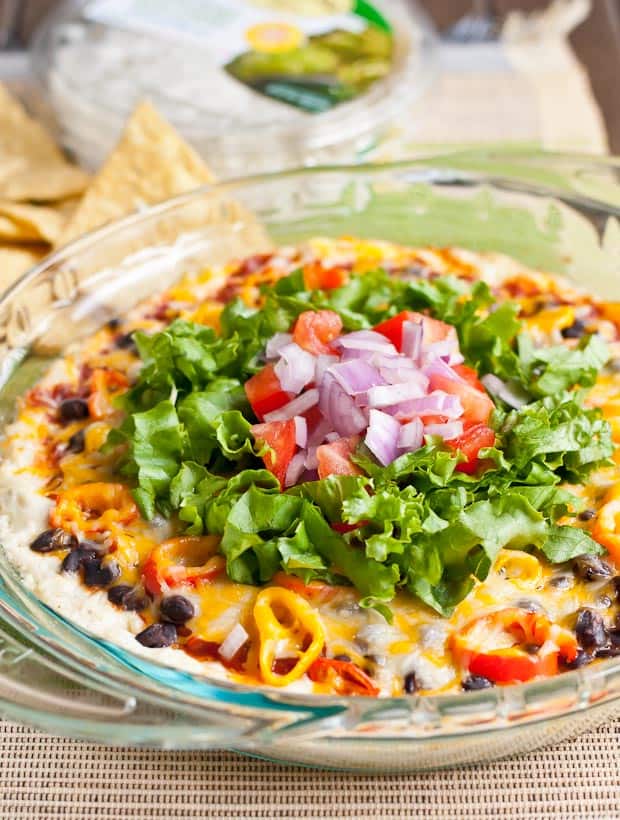 This warm Baked Jalapeno Artichoke 7 Layer Dip is creamy, cheesy goodness perfect for tailgating.