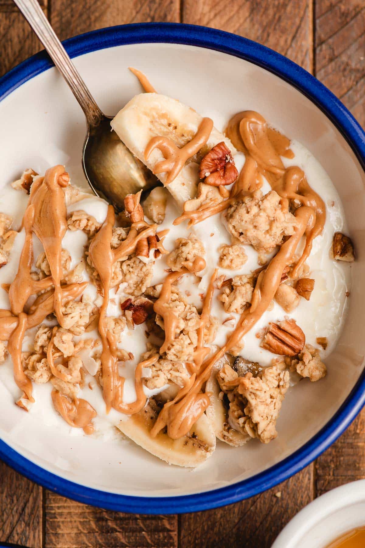 Breakfast Banana Split topped with peanut butter, pecans, and granola.