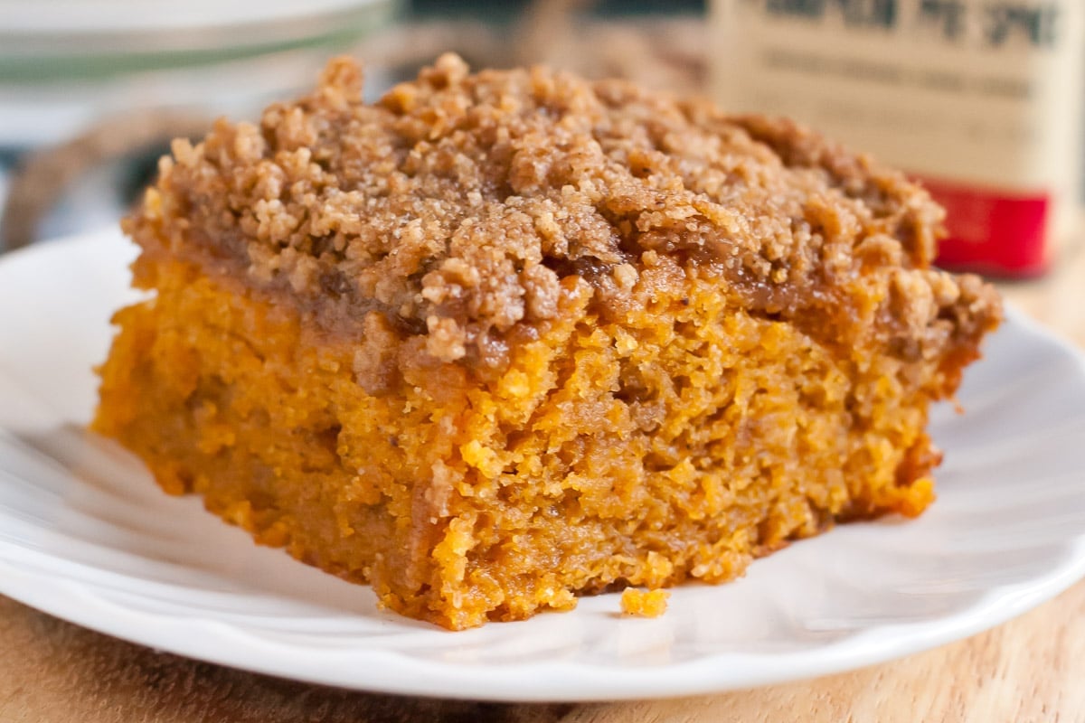 Pumpkin spice crumb cake slice on a plate.