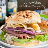 These Roast Beef and Turkey Sandwiches are piled high with salt and vinegar chips and a cream cheese spread. Perfect for tailgating!