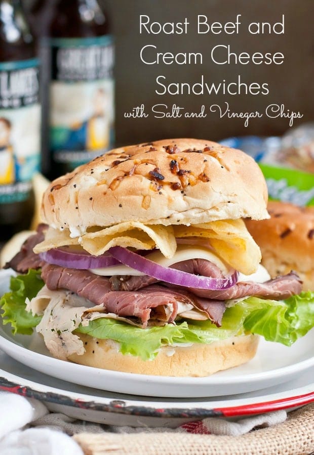 These Roast Beef and Turkey Sandwiches are piled high with salt and vinegar chips and a cream cheese spread. Plus learn how to make a killer tailgating spread!