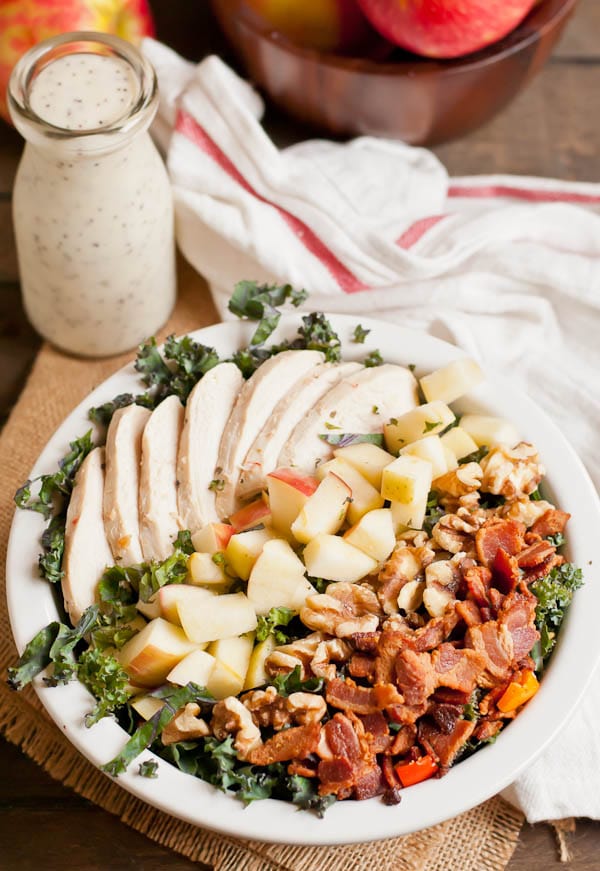 This healthy kale salad is loaded with chicken, bacon, apples, and walnuts.