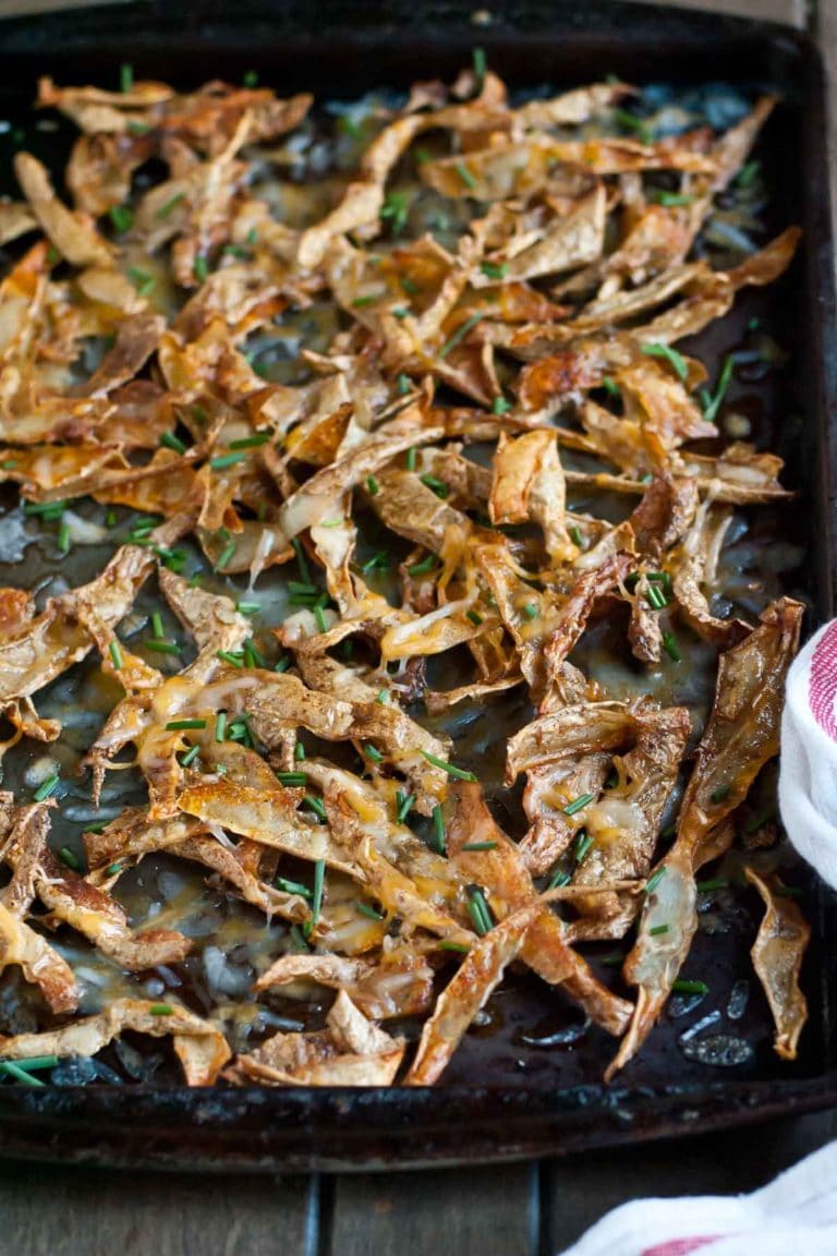 Never throw away potato peels again! Instead make these Crispy Roasted Potato Skins with cheese and chives!