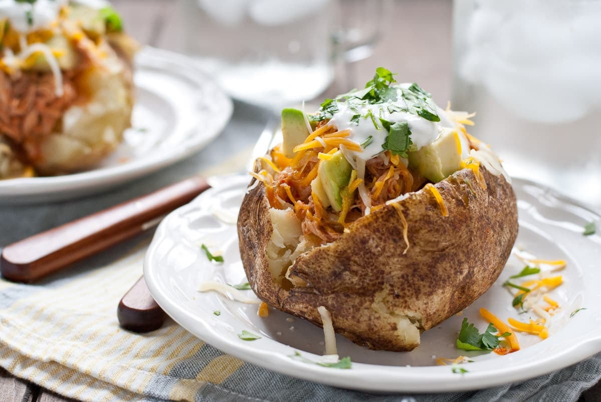 Loaded Baked Potatoes with chicken, avocado, sour cream, and cilantro.