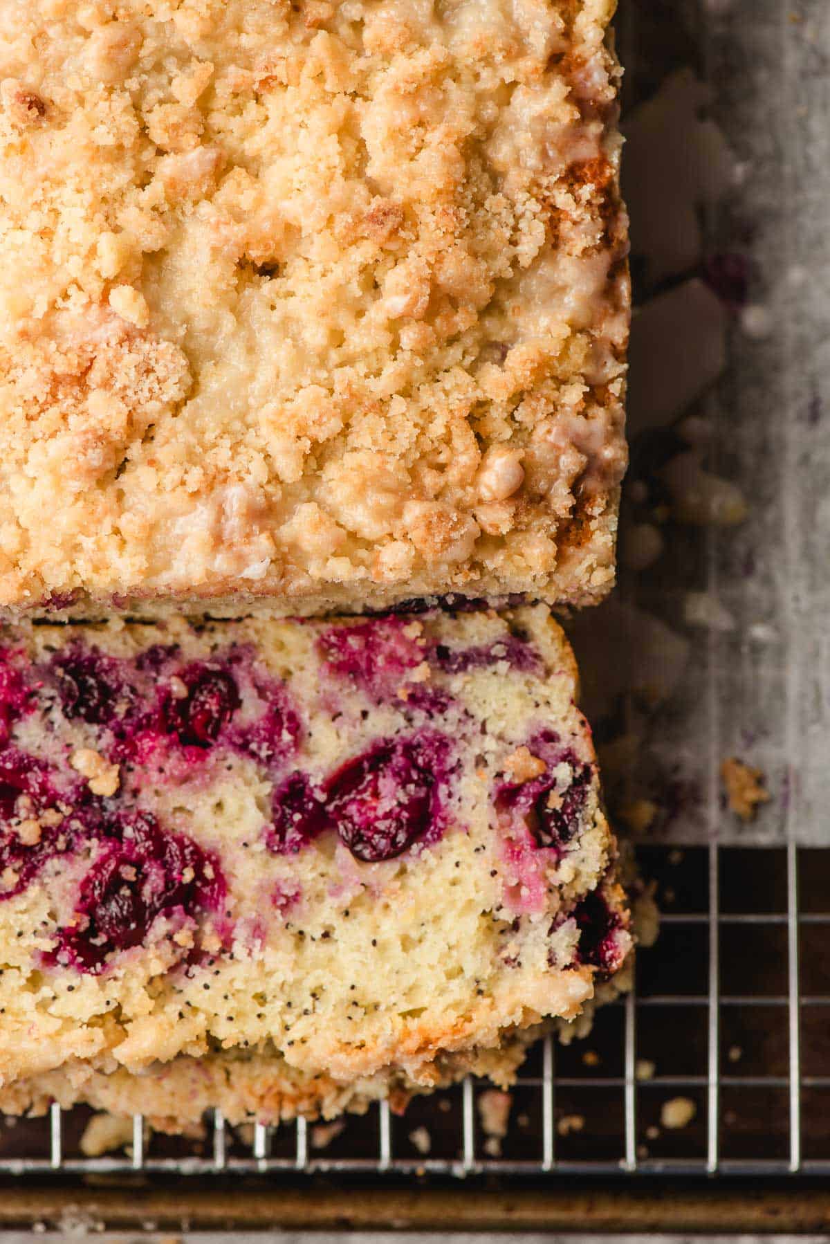 Overhead view of Lemon Blueberry Loaf Cake with a slice off the end.