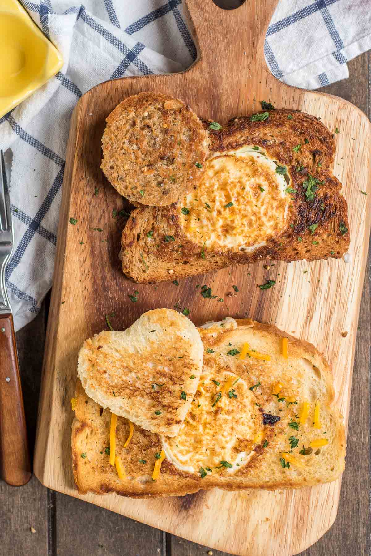Cooked eggs in a basket recipe served on a board