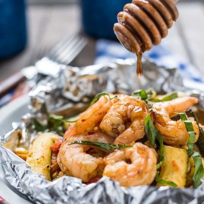 These Honey Garlic Shrimp Foil Packets with zucchini, tomatoes, and corn are the ultimate easy summer meal!