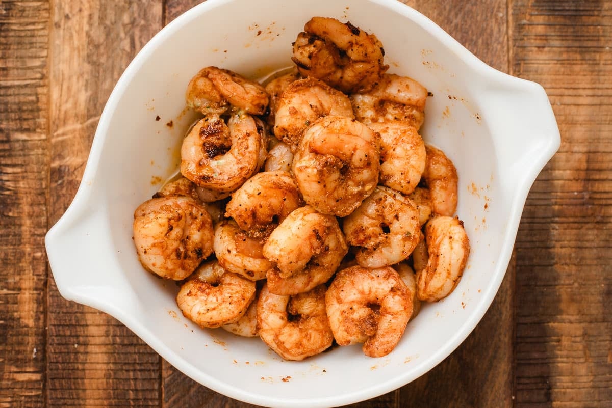 Taco seasoned shrimp in a white bowl.
