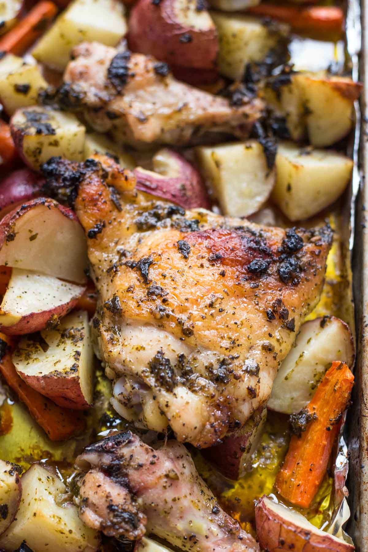 This Sheet Pan Pesto Chicken with potatoes and carrots is a ridiculously easy and tasty dinner idea!
