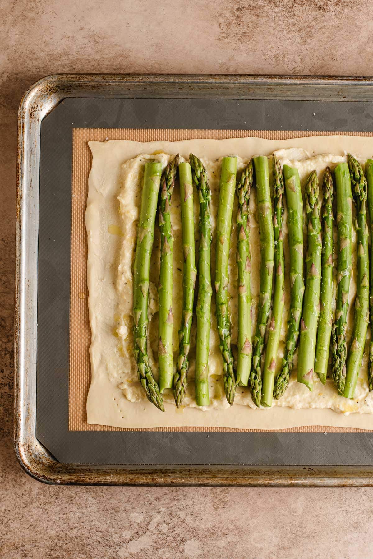 Asparagus spears on top of ricotta and puff pastry.