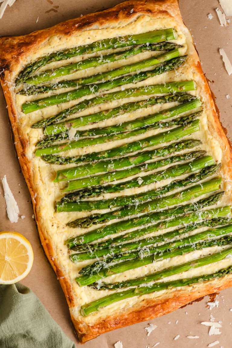 Puff pastry tart topped with ricotta, parmesan, and asparagus tart.
