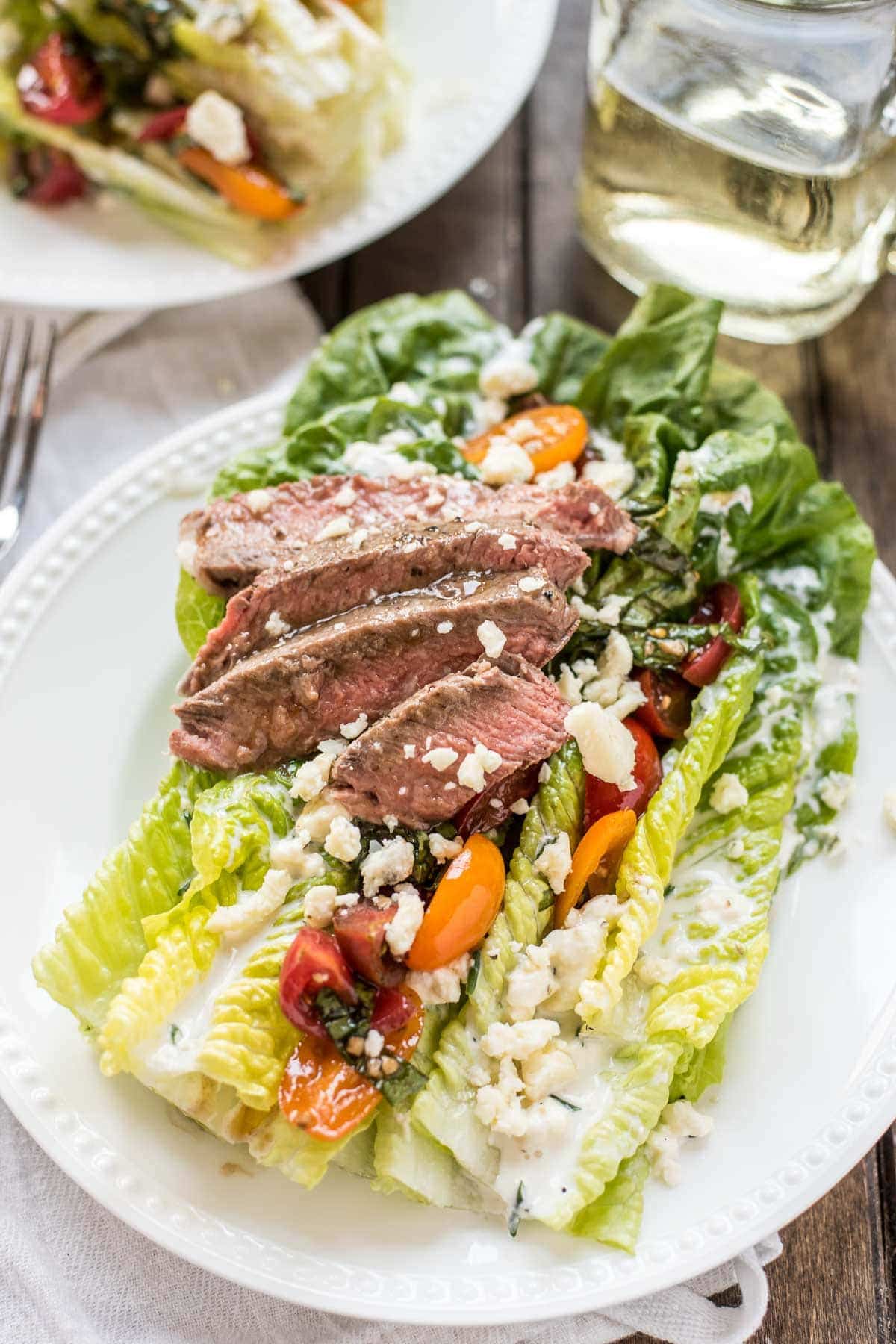 This gorgeous Steak and Blue Cheese Salad is loaded with bruschetta cherry tomatoes, homemade buttermilk dressing, blue cheese crumbles, and ribeye steak!