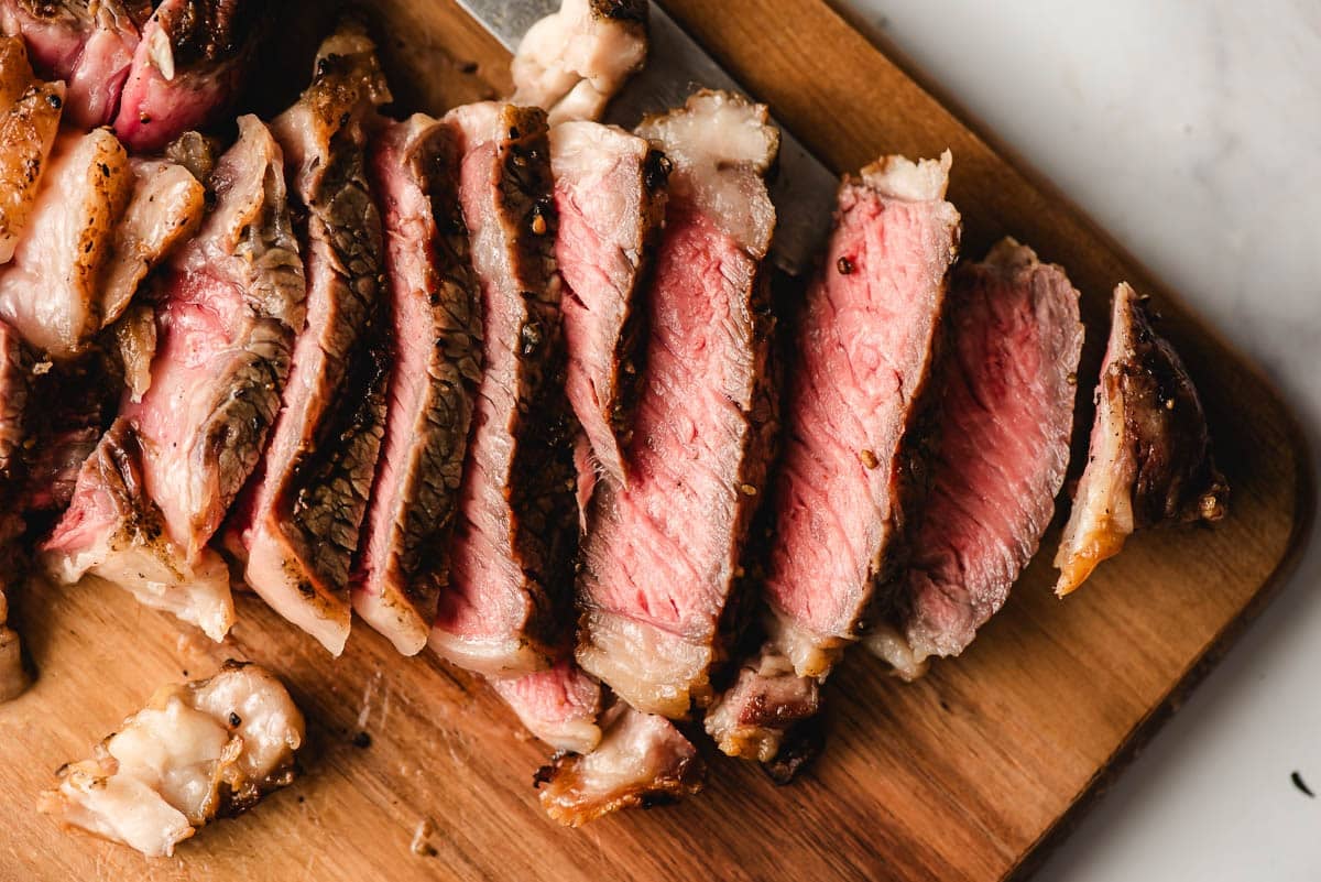 Grilled ribeye steak sliced into thin slices.