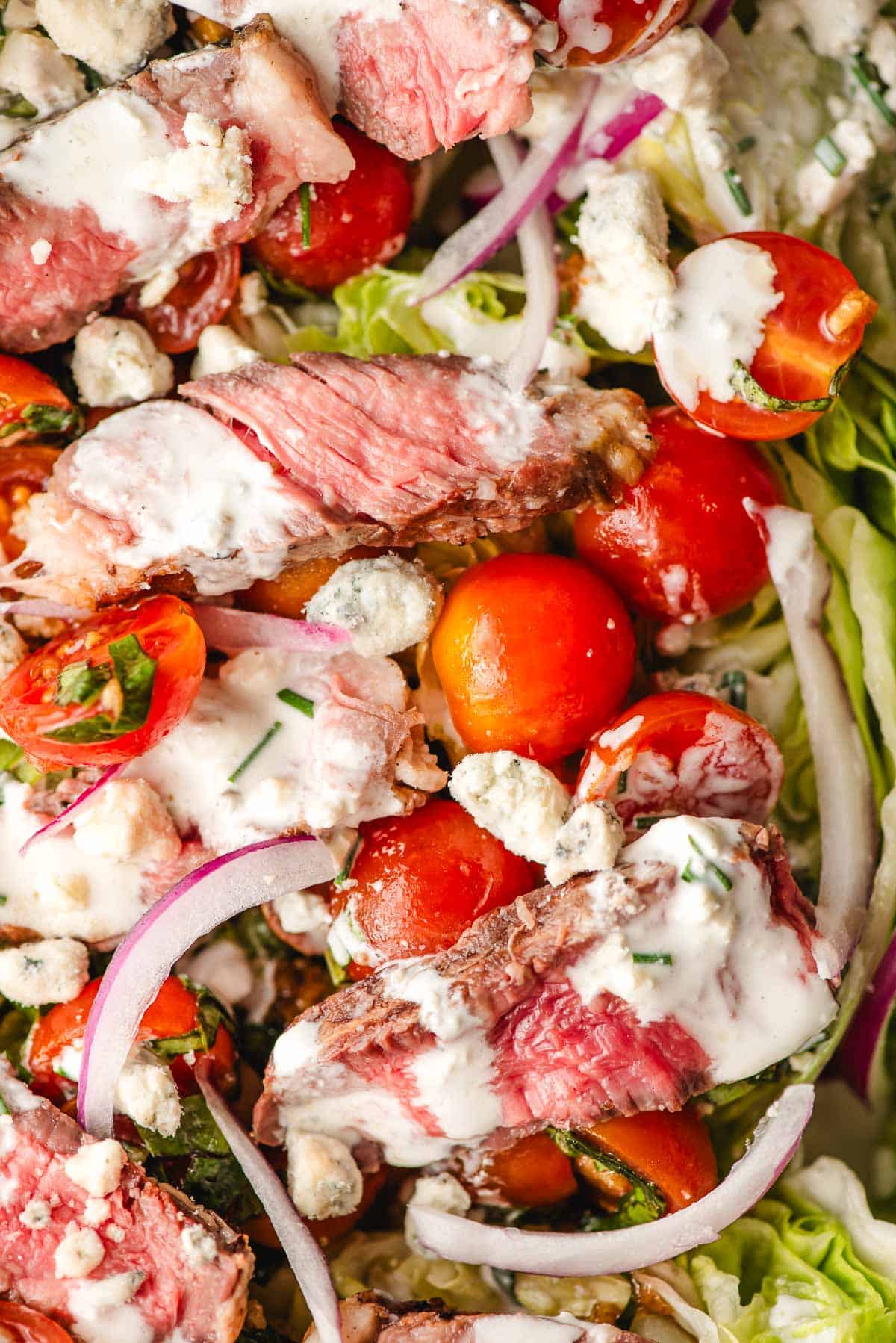 Wedge salad with grilled steak, blue cheese dressing, and bruschetta tomatoes.