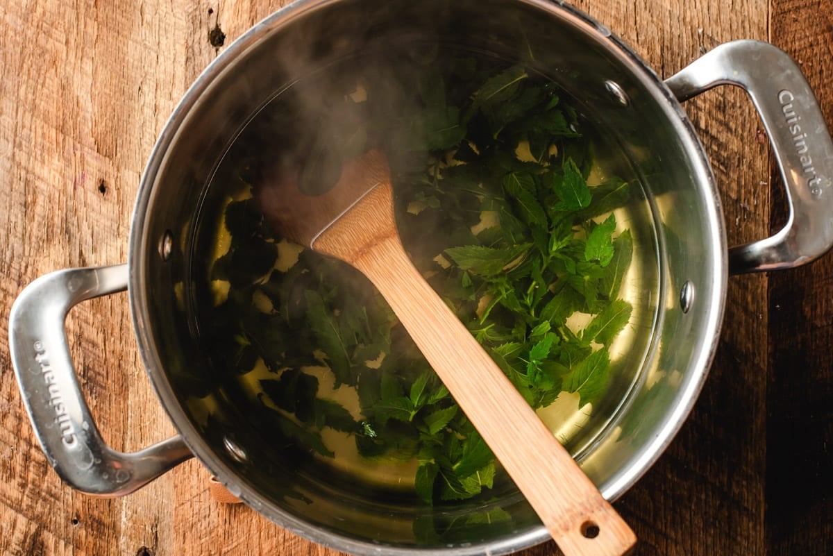 Mint tea leaves steeping in boiled water.