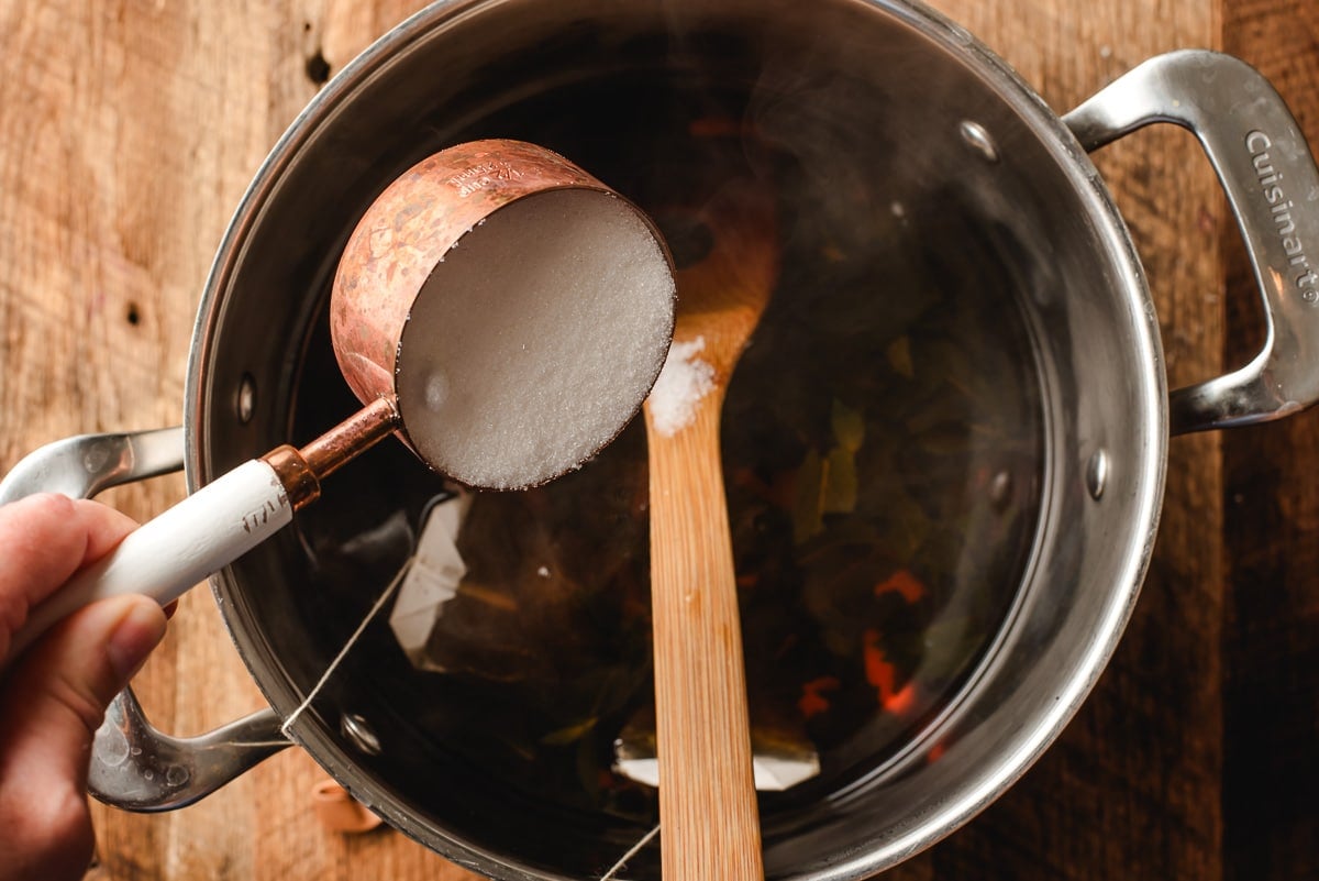 Sugar being poured into mint tea.
