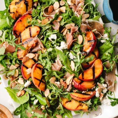Bit platter of Grilled Peach Salad with prosciutto, goat cheese, and almonds.