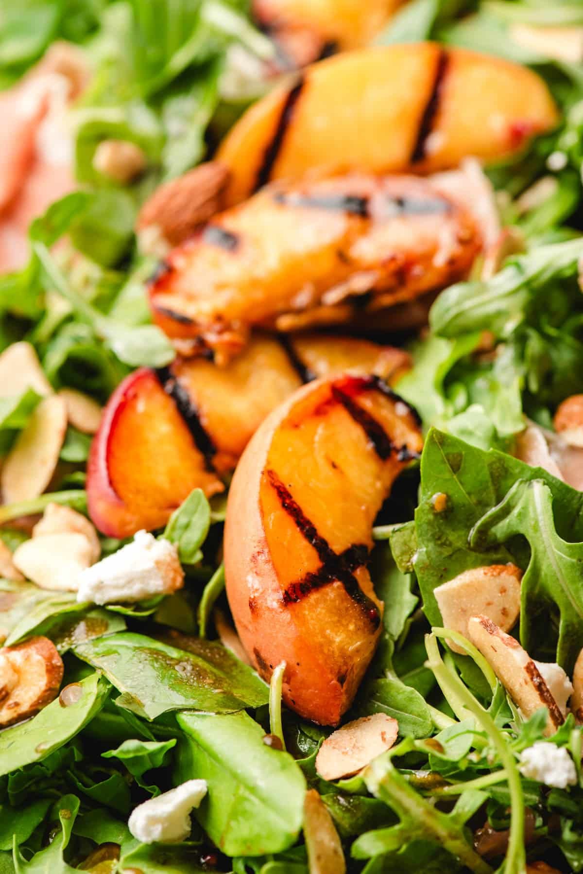 Grilled peach slices with salad greens.