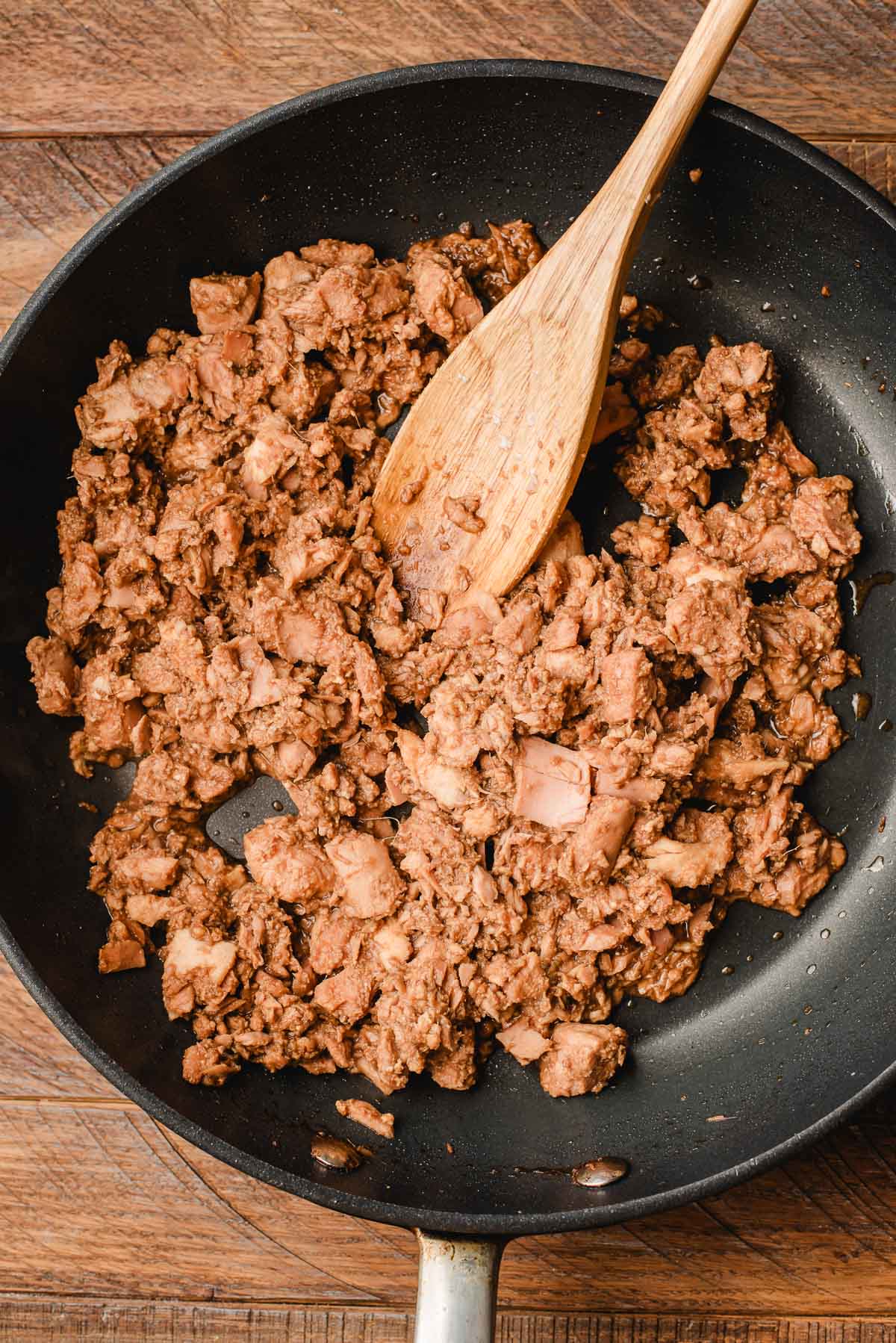 Canned tuna cooked with soy sauce, rice vinegar, garlic, and ginger in a skillet.