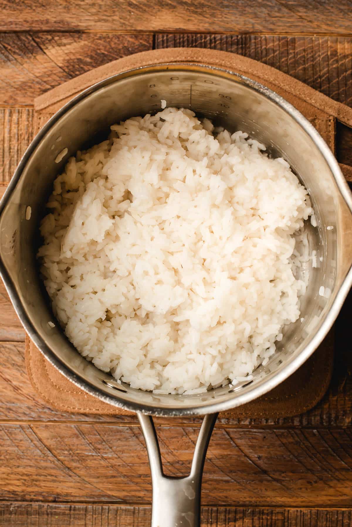 Cooked white rice in a sauce pot.