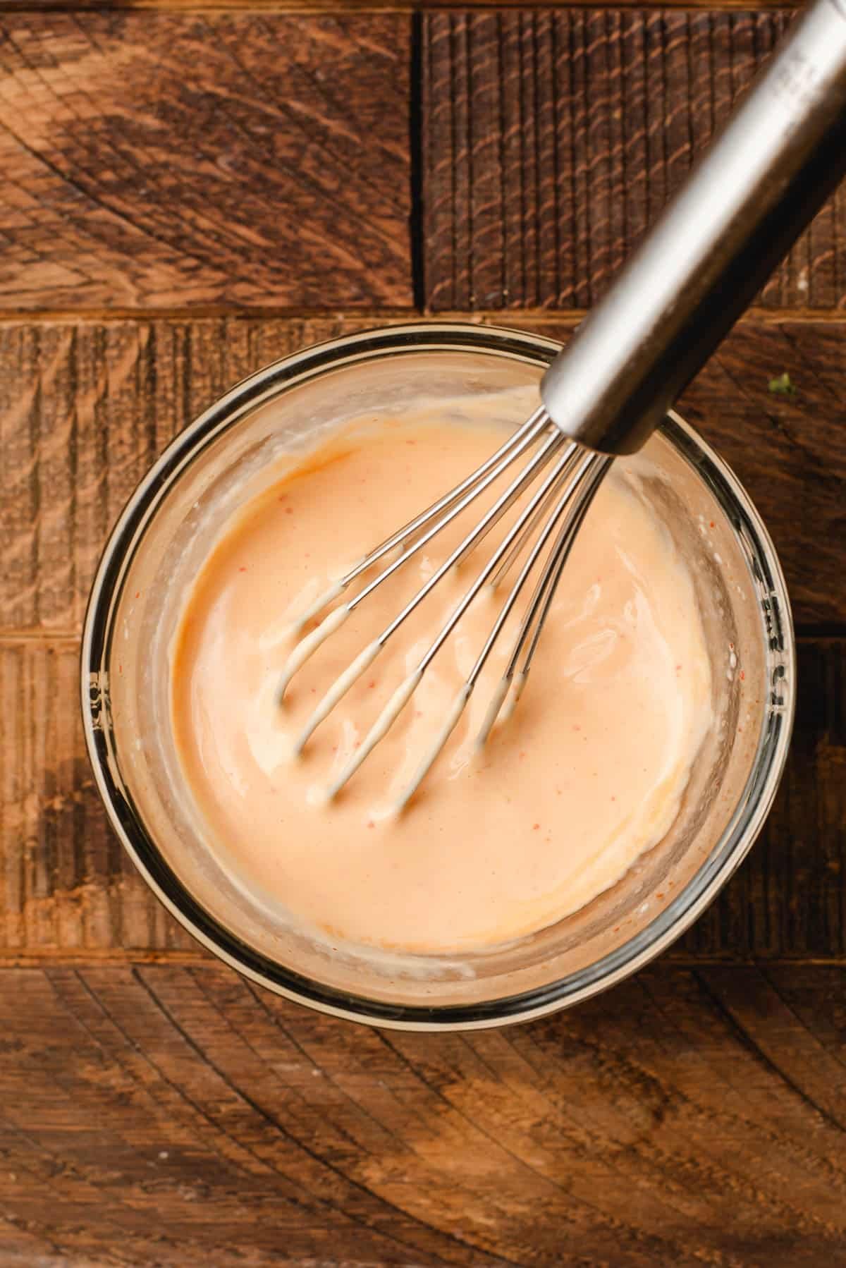 Mayo, Sriracha, and lime juice whisked together in a small bowl.